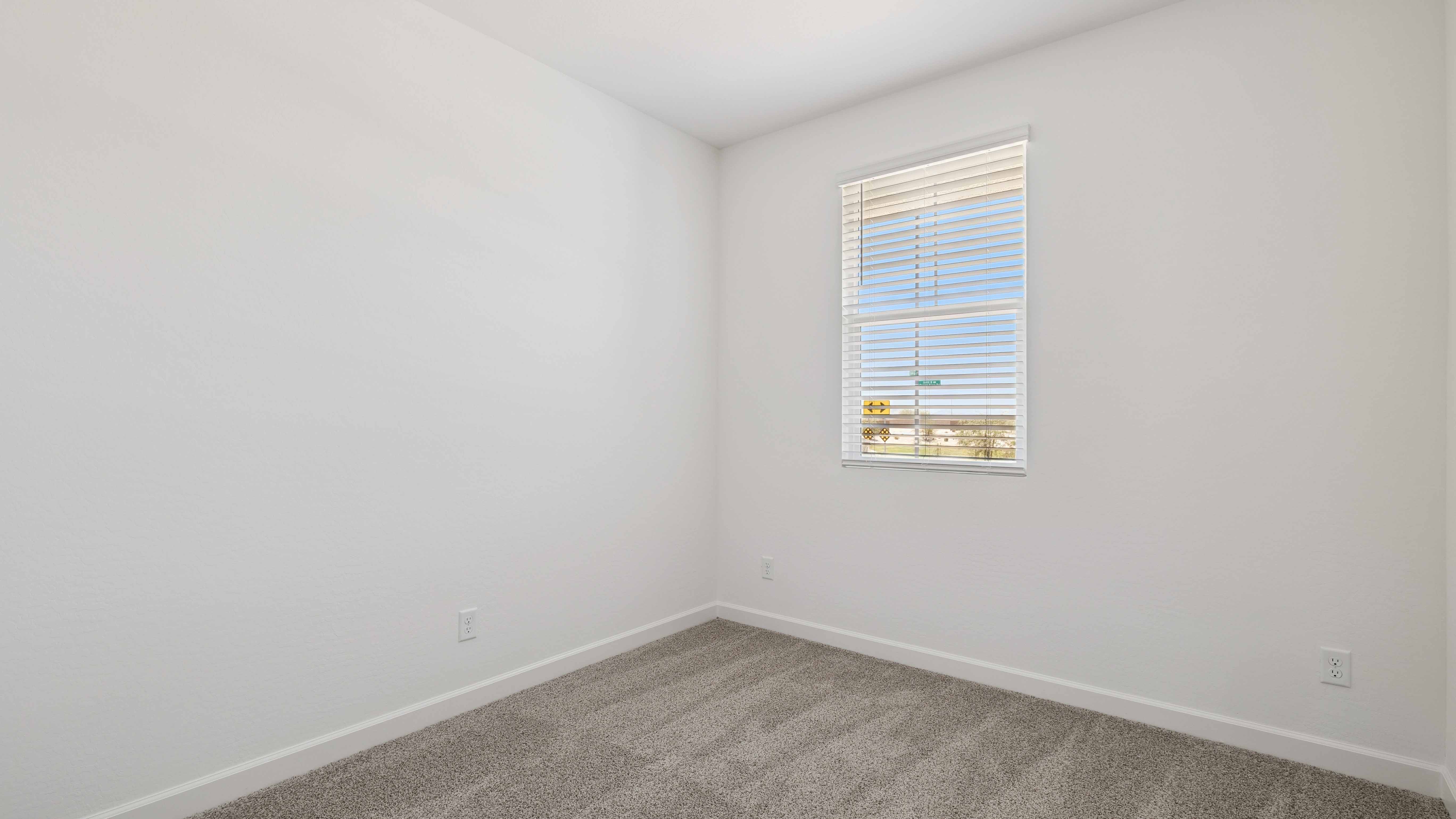 Comfortable guest bedroom featuring neutral-toned walls and a large closet.