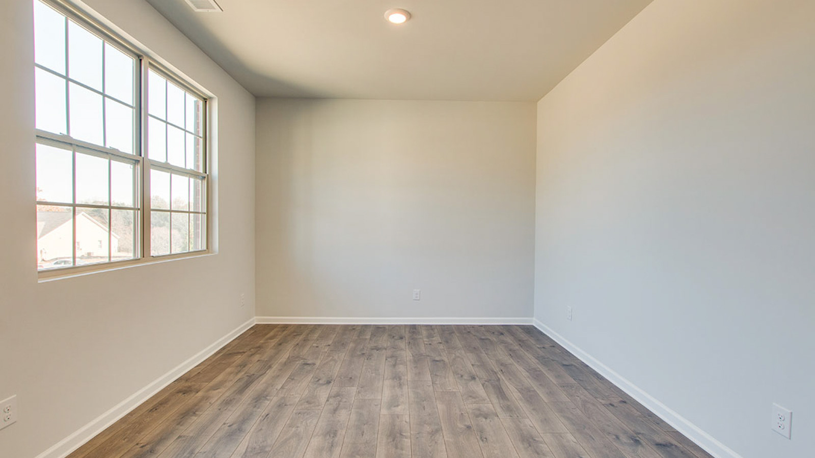 Dining room in new, open-concept home with windows and natural lighting