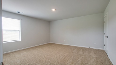 Bedroom in modern, open concept new home