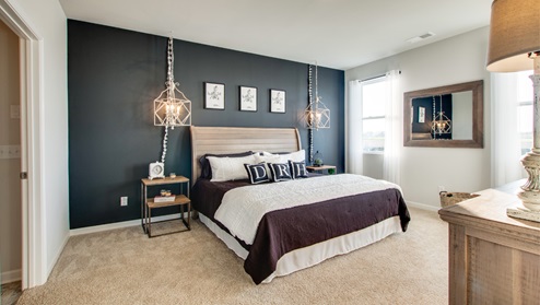 Main bedroom furnished with accent wall and furtiture