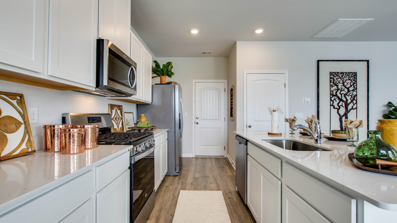 Interior kitchen with center island and white cabinets