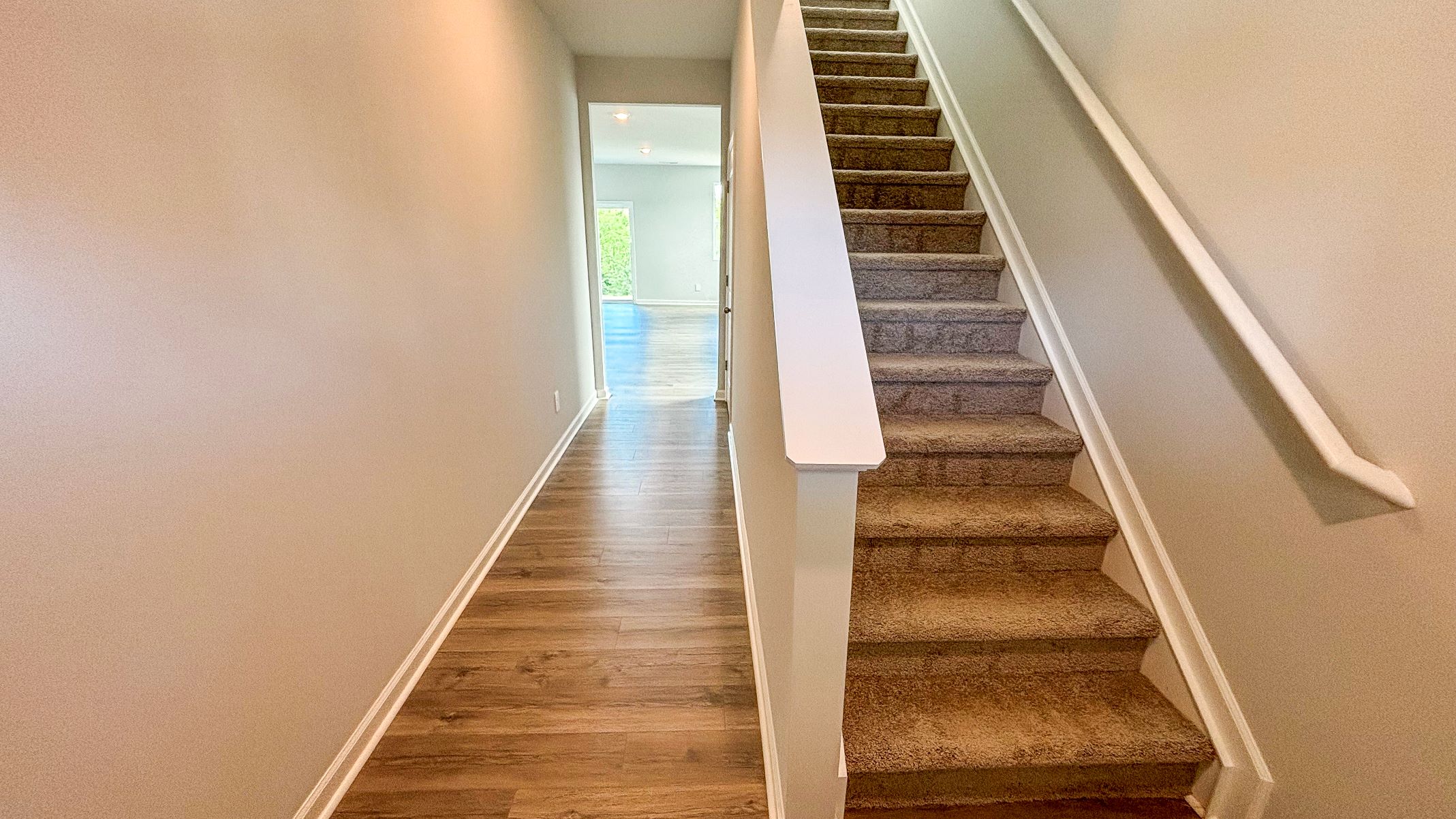 Our new home presents an entry hallway, stairway upstairs access connecting the front to the main gathering areas