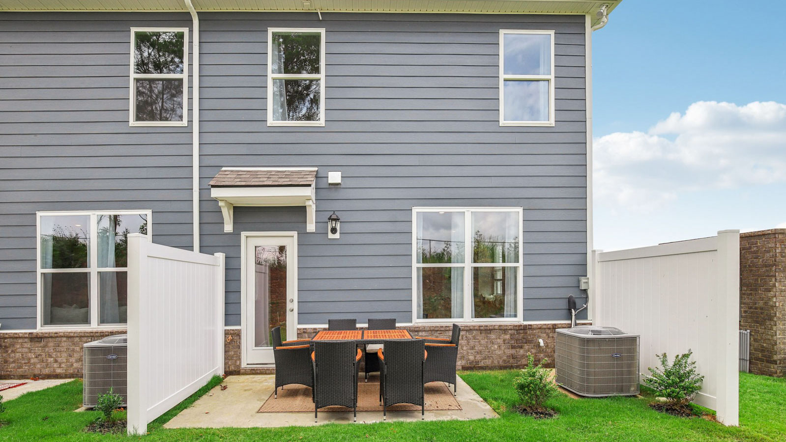 Back porch view of a two story end-unit townhome