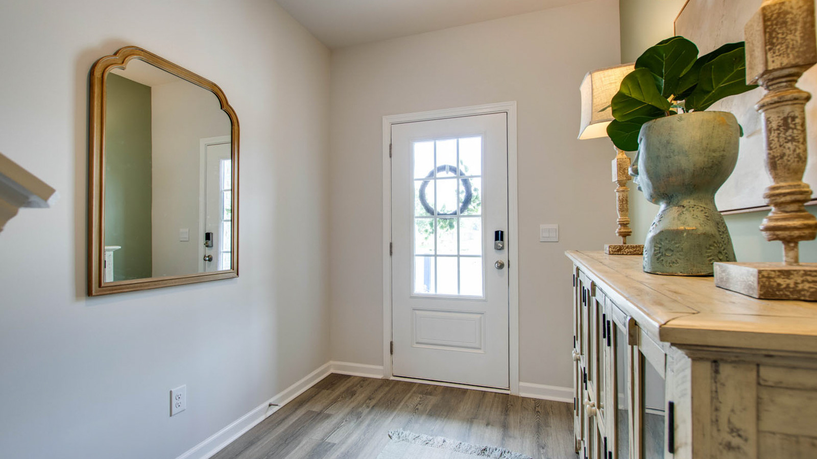 A foyer, entry hall inside front door, next to office, or sitting room adding a welcoming front, direct line of sight to home
