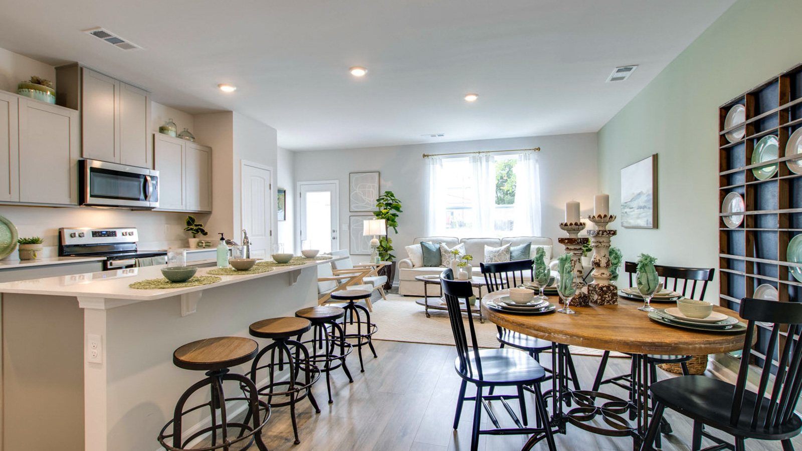 Central kitchen island anchors the home adding a dining option, full sink, pantry and storage, multi-prep zones