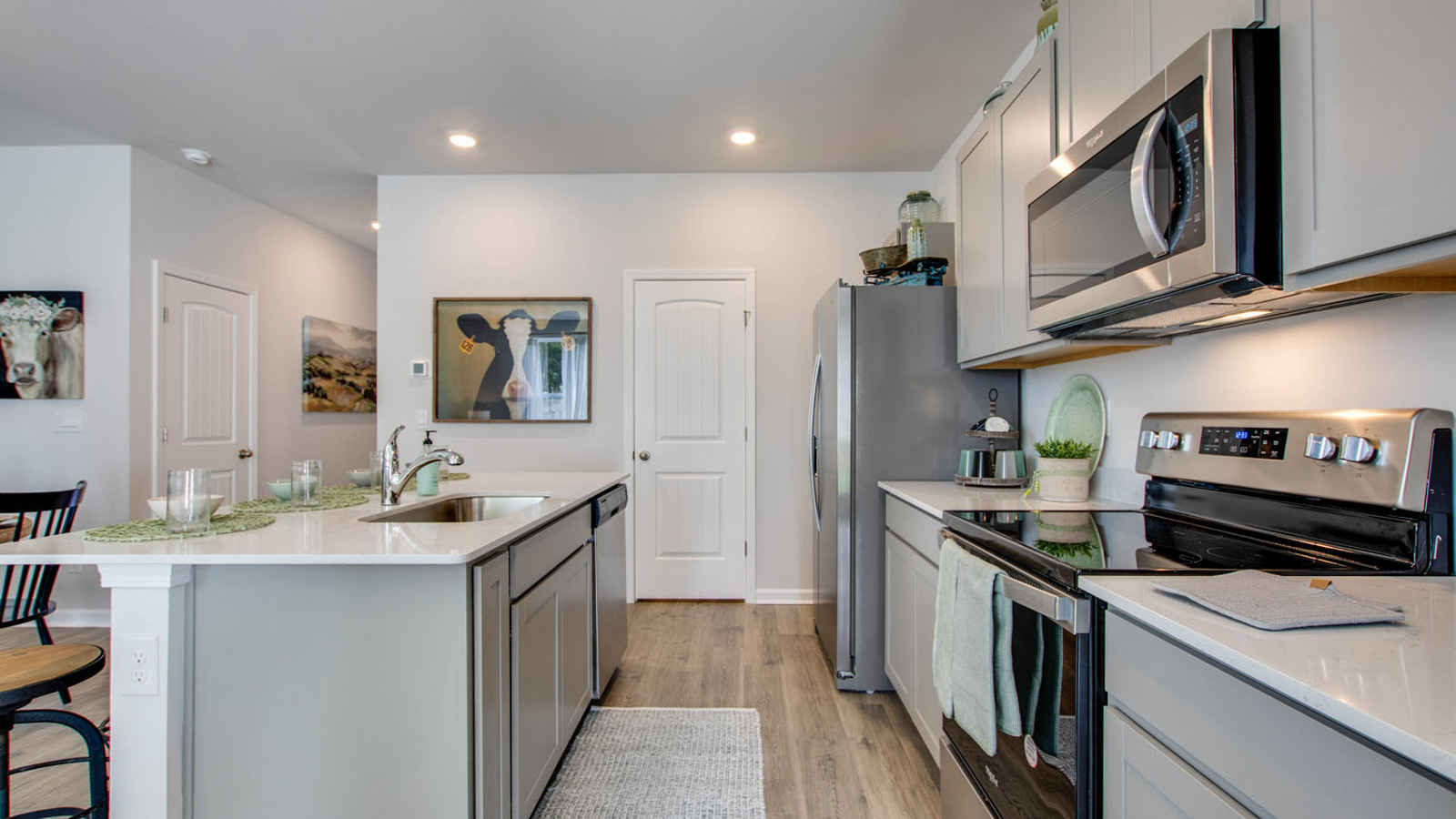 New appliance suite included, our larger kitchen island with seating anchor the kitchen, next to dining, great rooms, pantry