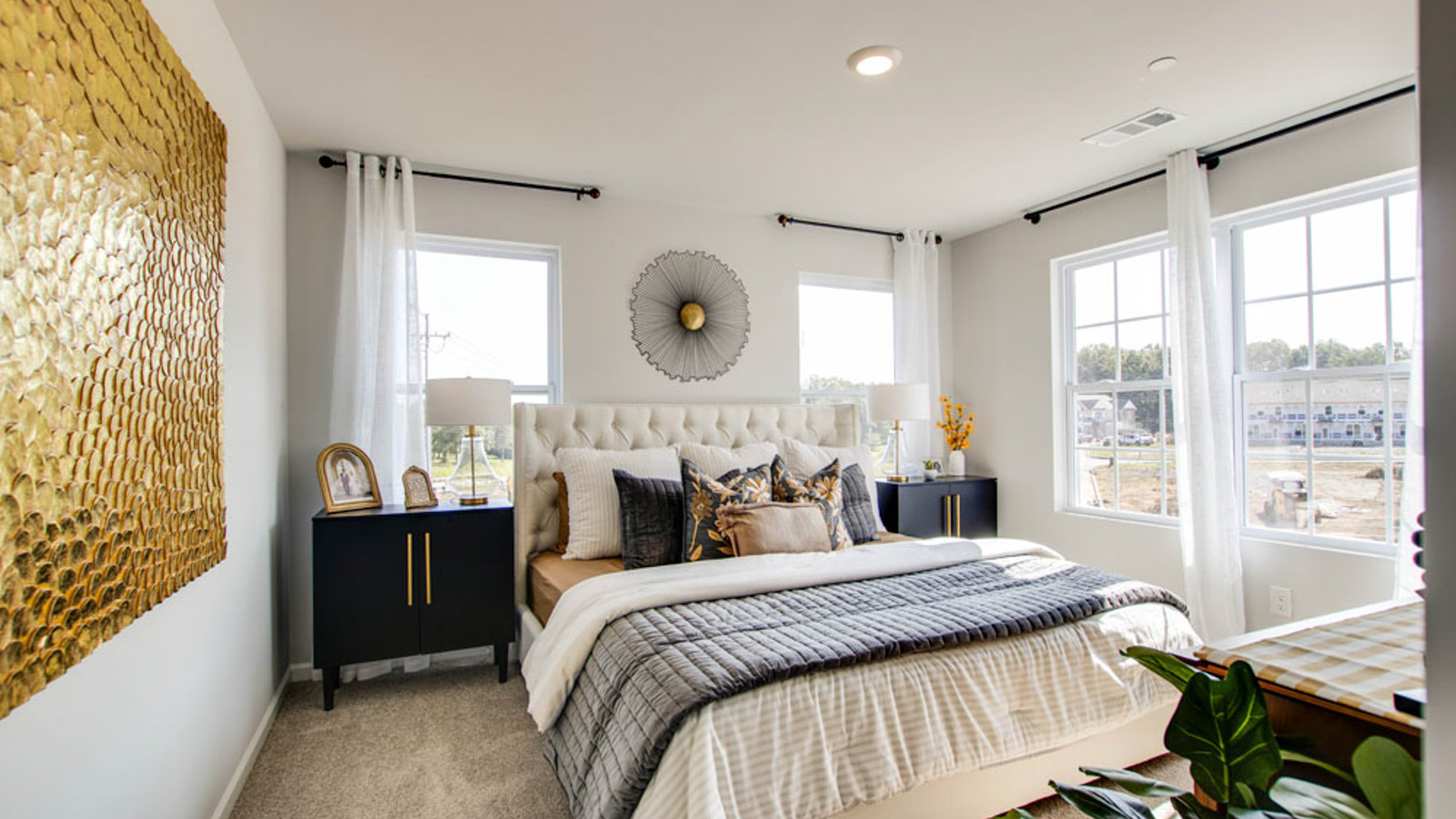 Primary bedroom features ample space, double windows, soft carpet, a stylish walk-in closet, and a private ensuite bath