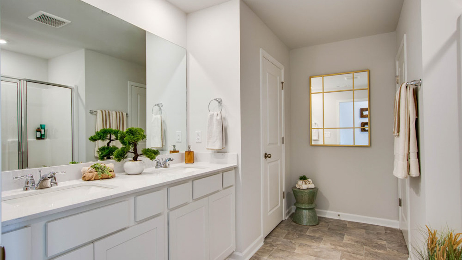 Primary bedroom in this townhome features ample space, double windows, soft carpet, walk-in closet, and a private ensuite bath