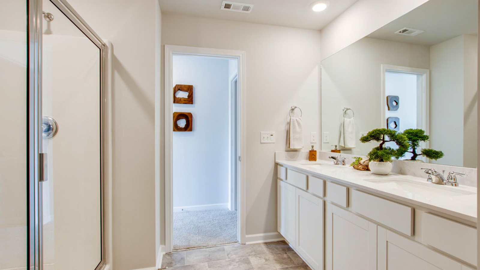 Owner’s ensuite in a new build townhome adds functional layout with a walk-in closet, and spa-like shower,bath walk-in closet