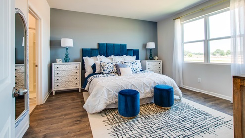Bedroom with light brown flooring.