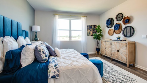 Bedroom with large window for natural lighting.