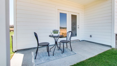 Covered back patio in backyard.