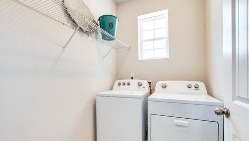 Laundry room with tile flooring.
