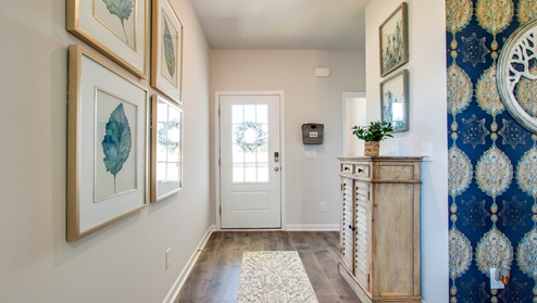 Front entryway of home with light brown flooring,