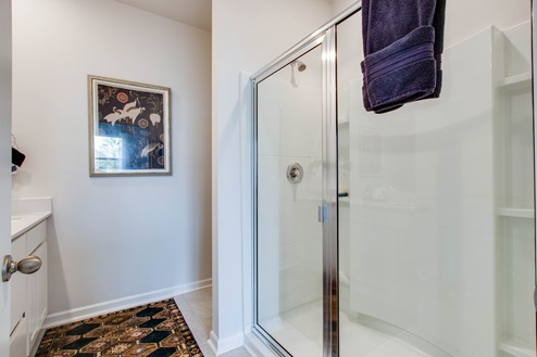 Shower with glass doors.