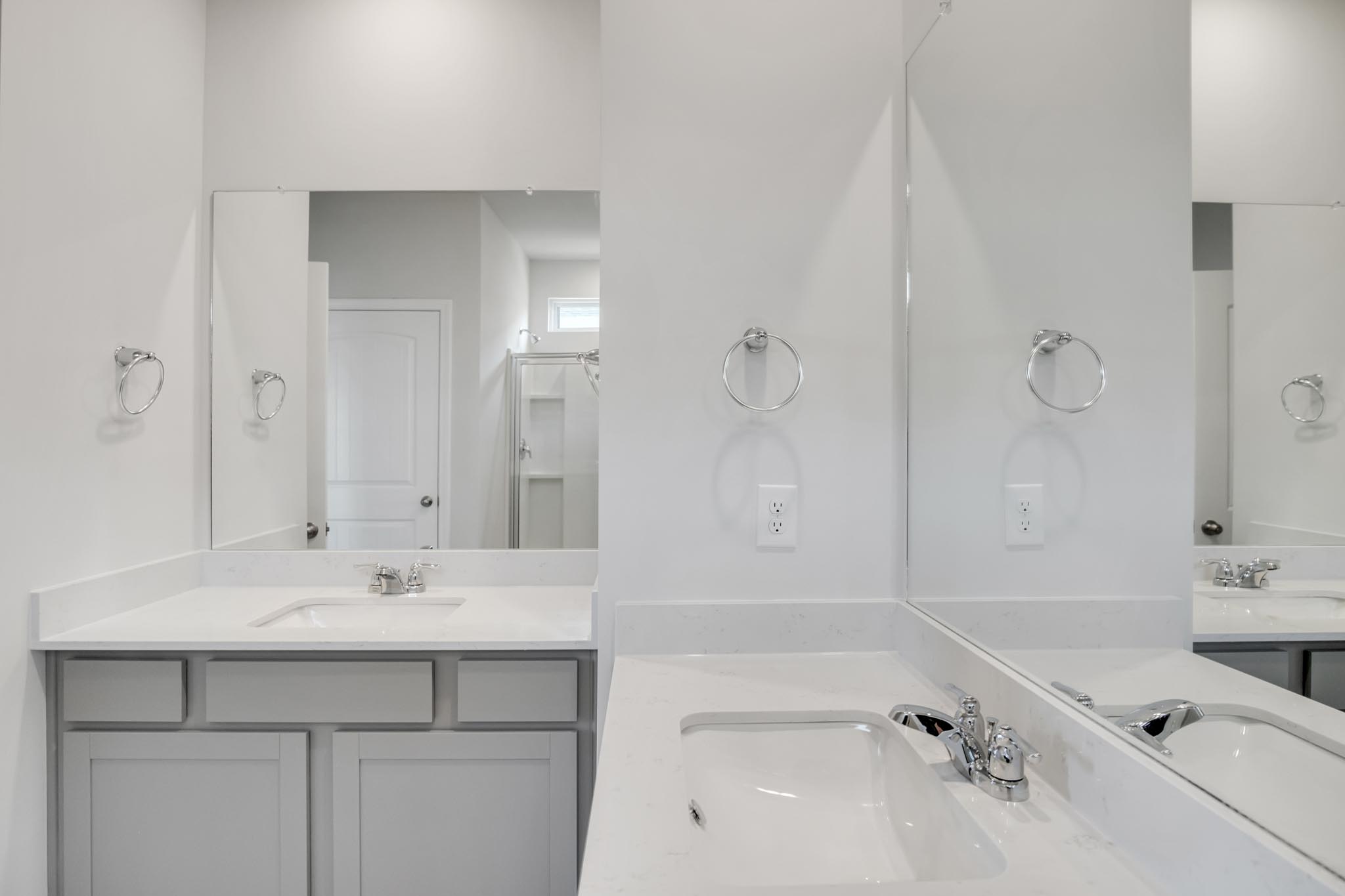 Bathroom with two separate sinks.
