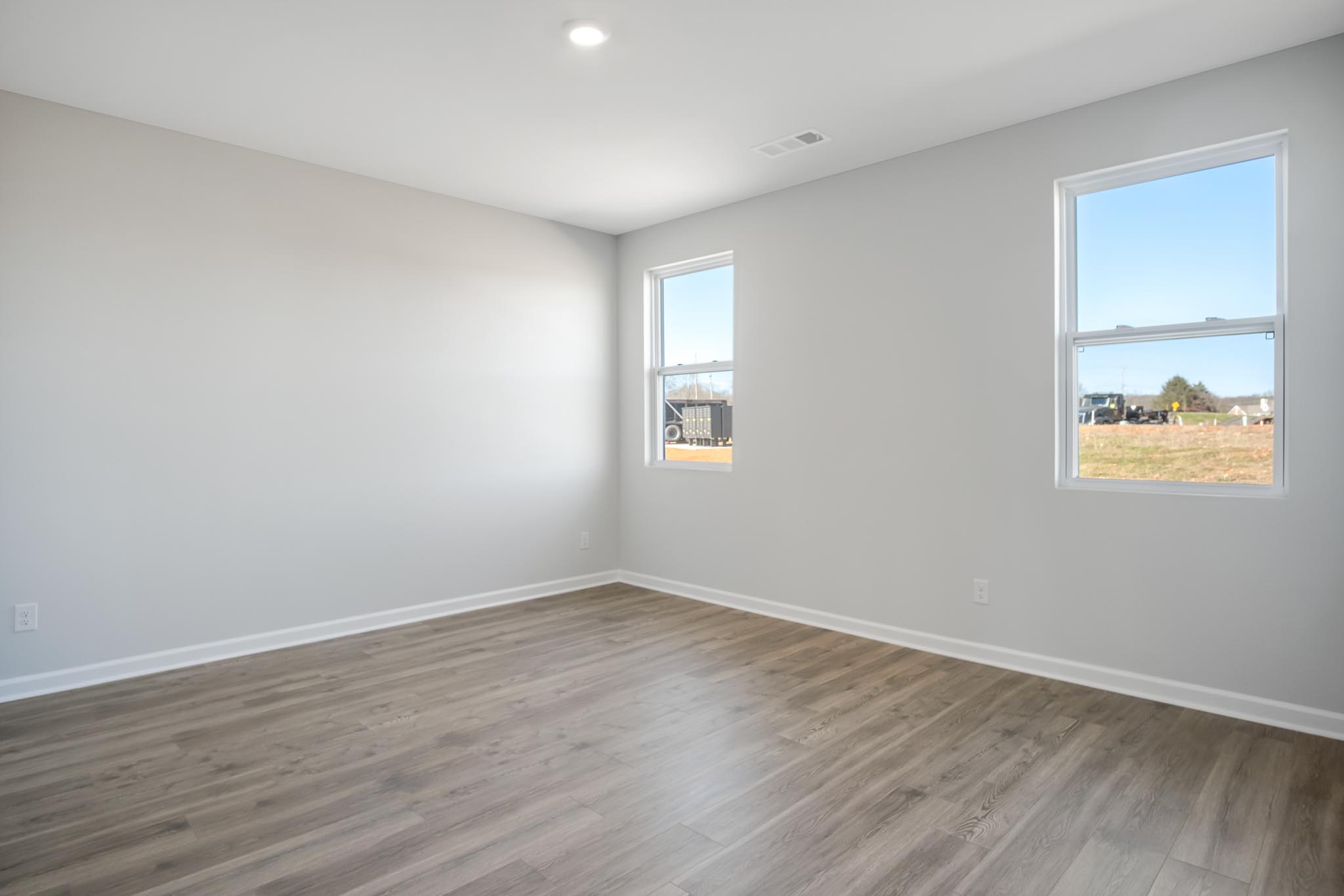Bedroom with two windows for natural lighting.