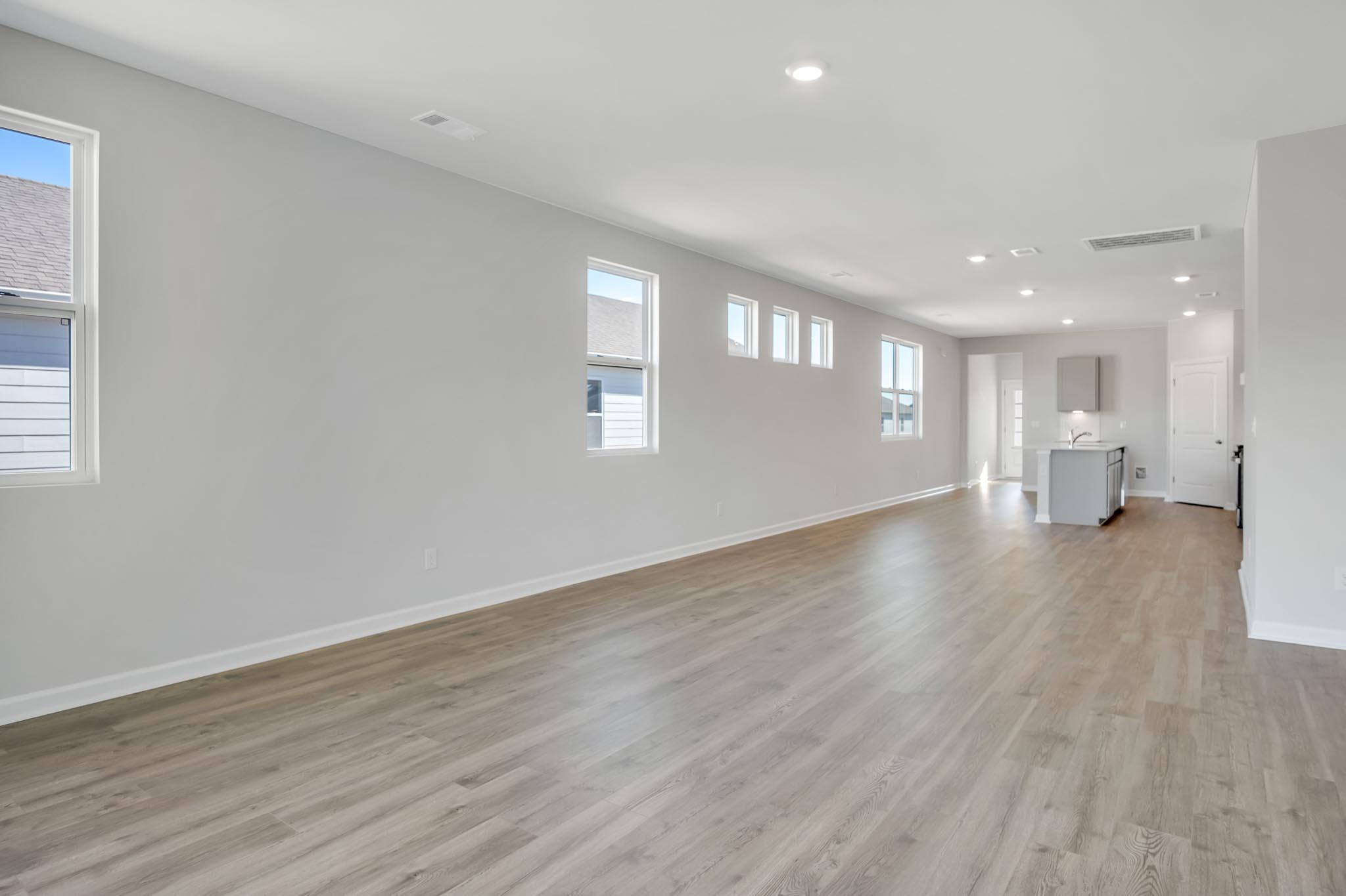 Living room with open view of kitchen.