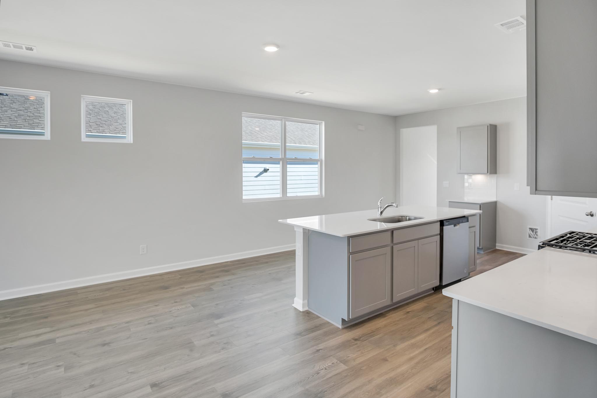 View of kitchen with large window for natural lighting.