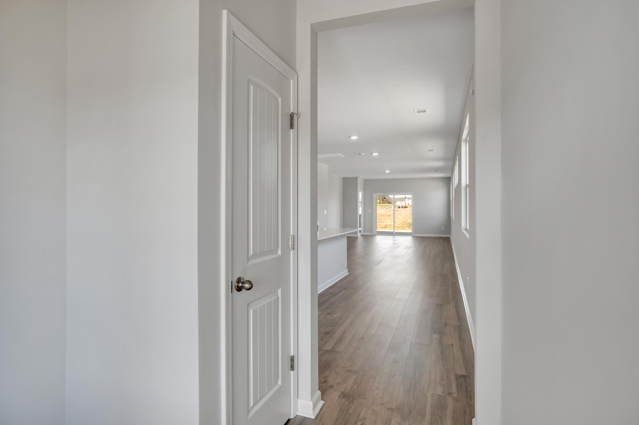 View of kitchen and living room from front entry room.