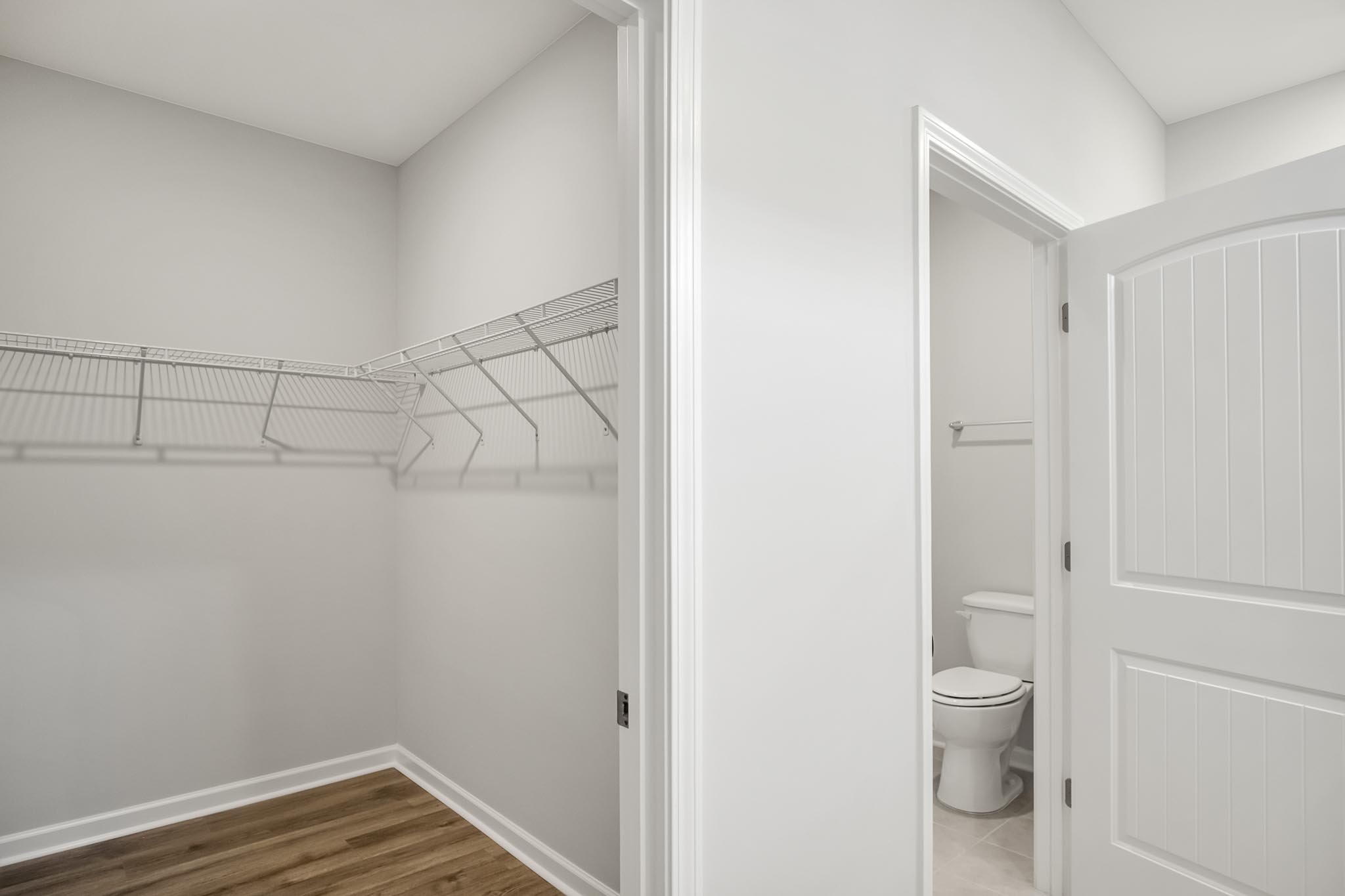Walk in closet with tile flooring.