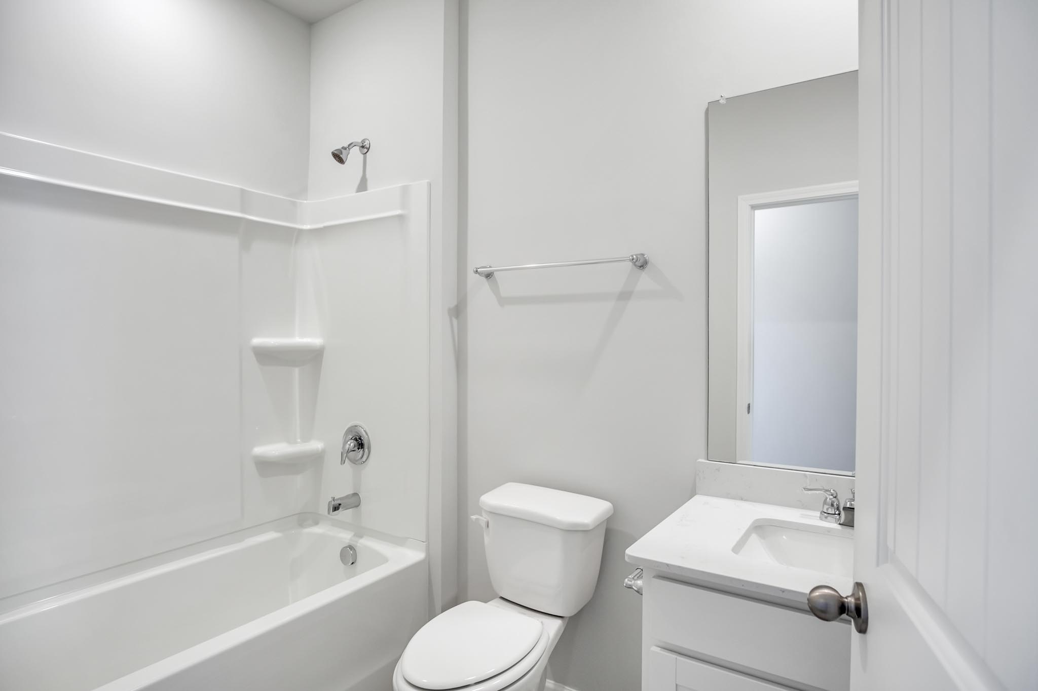 Bathroom with single sink and step in shower.