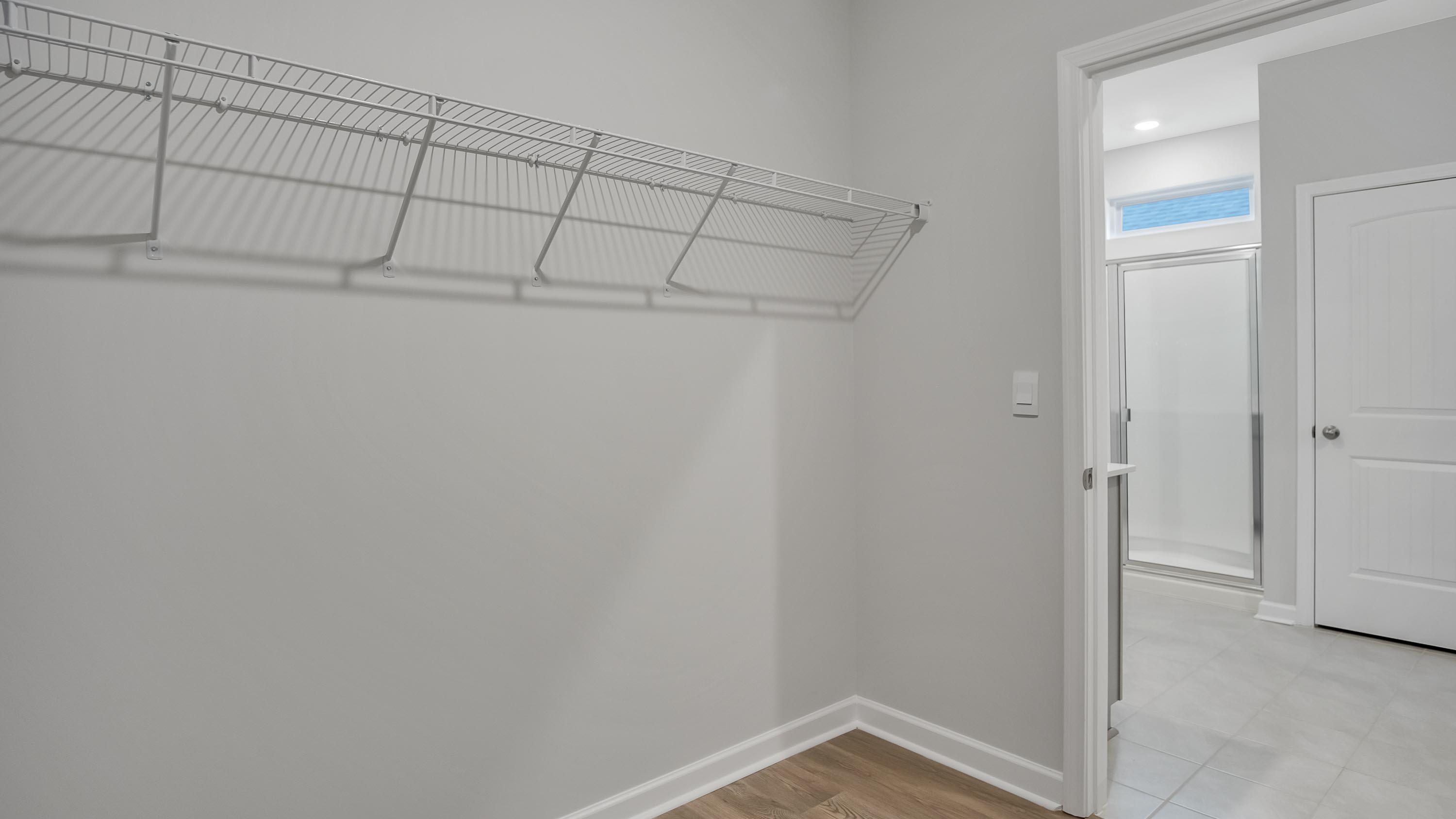 Interior view of walk-in closet in the primary bedroom, spa-inspired ensuite in Legacy Farms, a new home by D.R. Horton