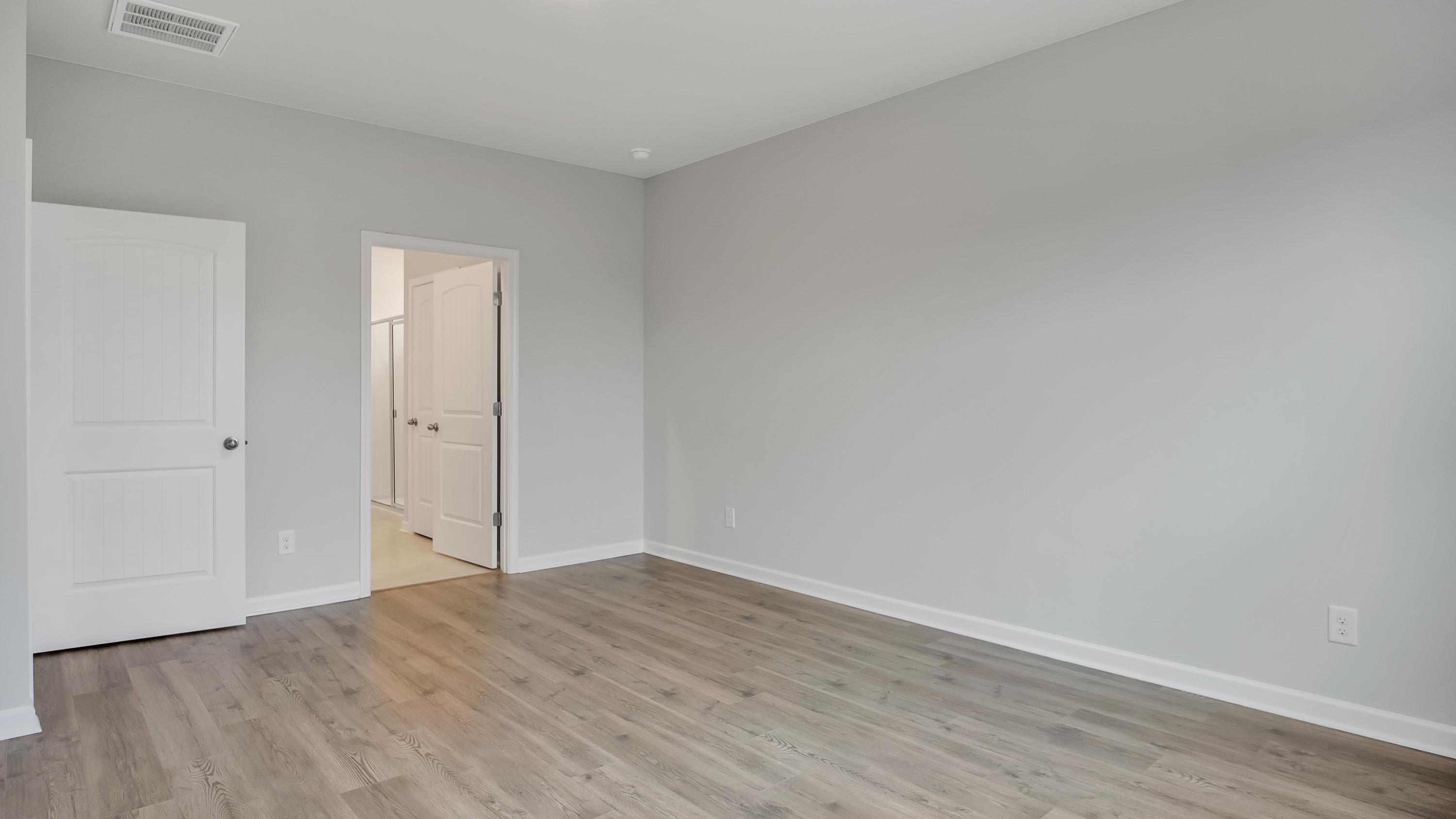 Primary bedroom designed with privacy and space in mind with a flow into a spa-inspired ensuite bathroom and walk-in closet