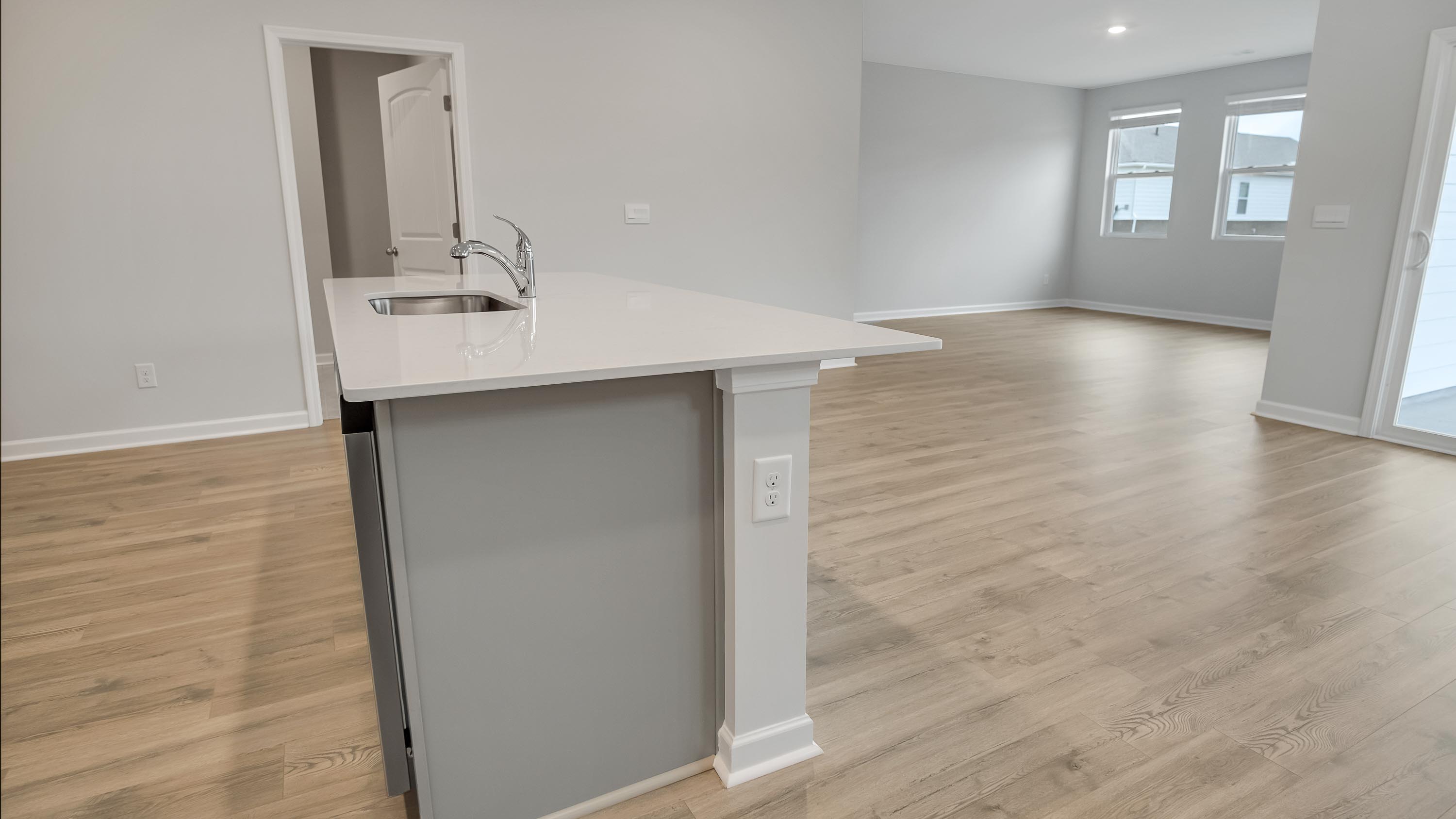 Central kitchen island adds a sink, seating, designed to anchor the home, pantry, prep zones, perfect for entertaining, everyday life