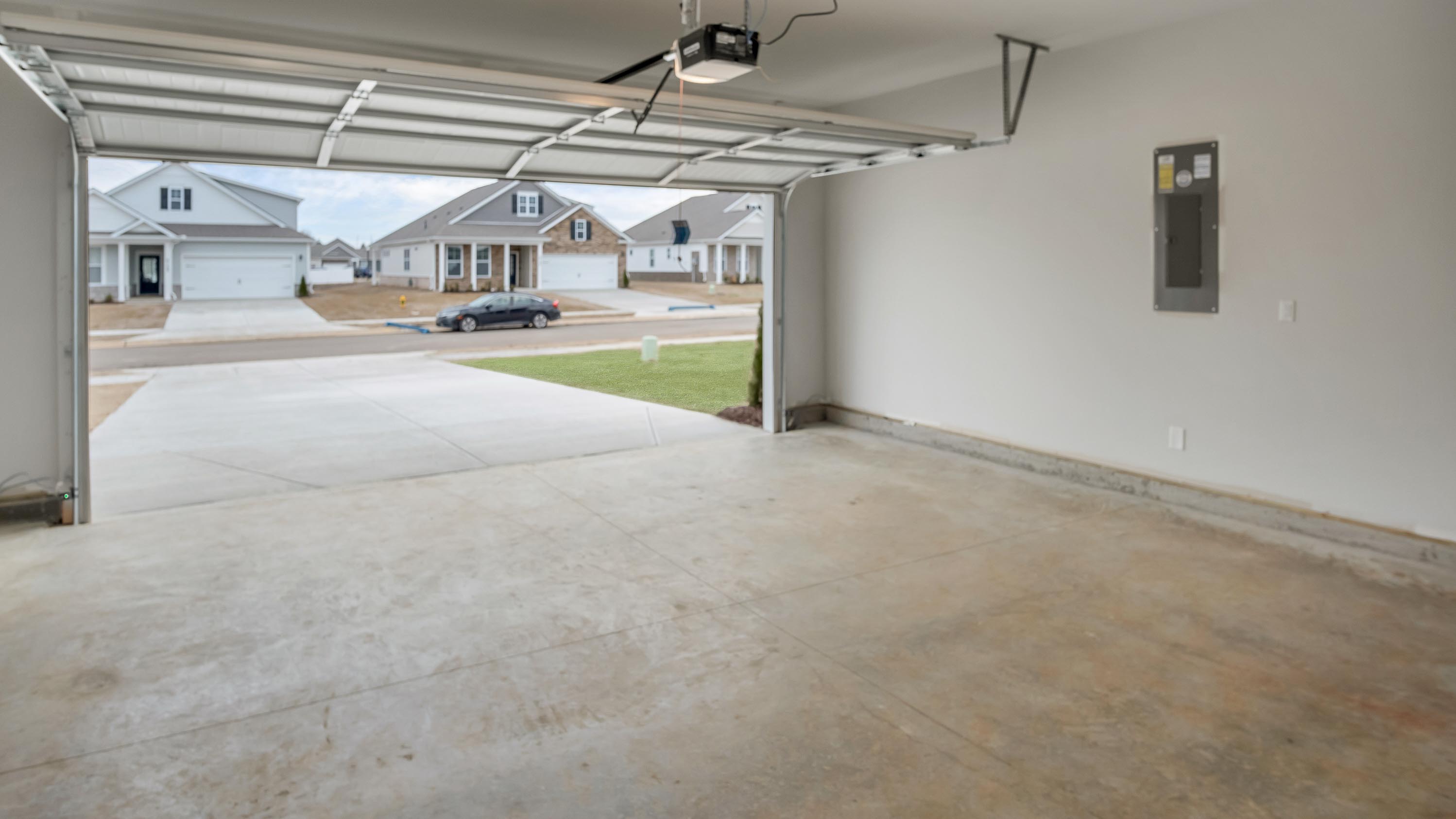 Inside view of two-car garage. Garage door, storage options in our Legacy Farms new home, featuring one-story connectivity