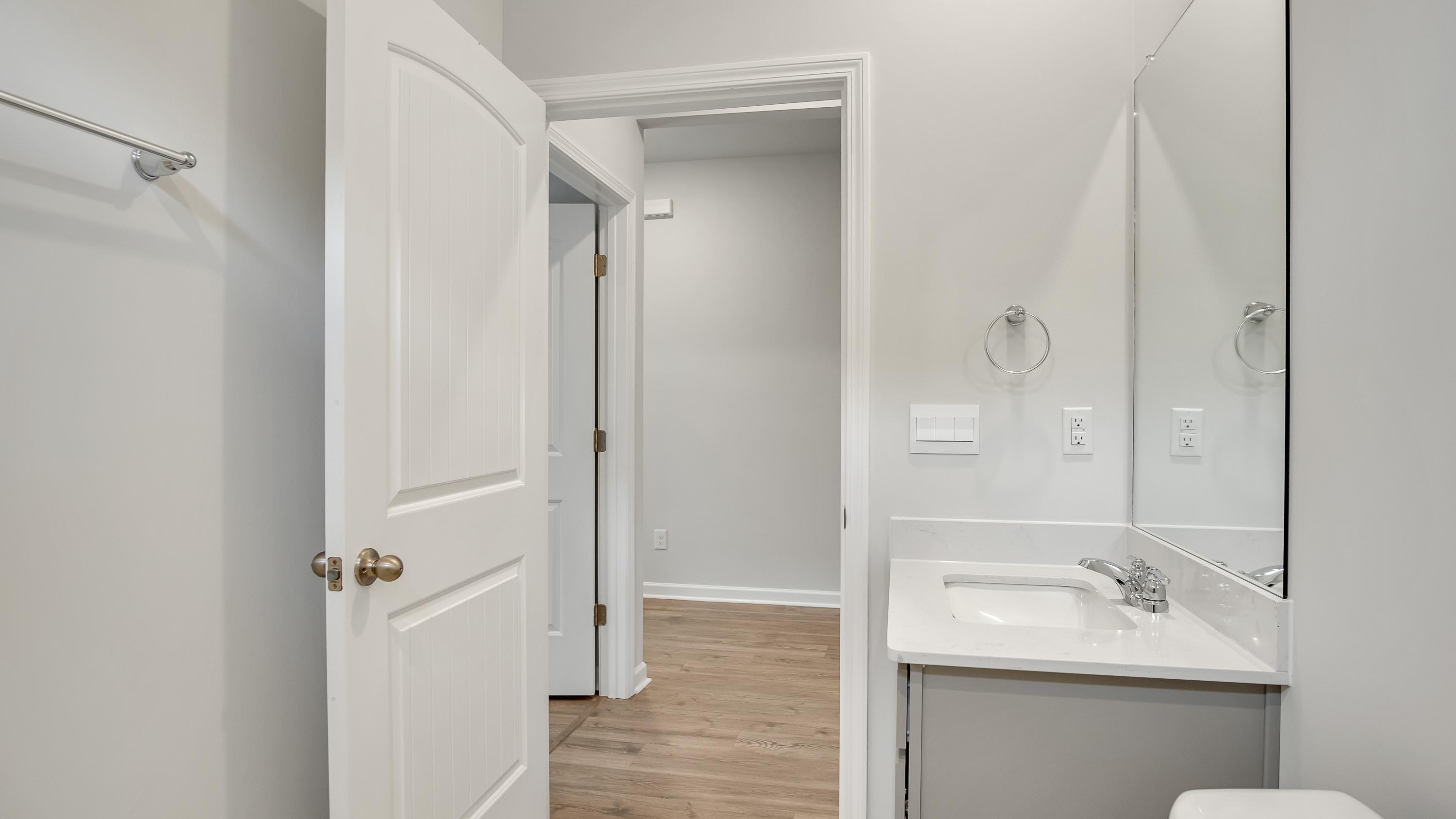 Secondary bath with built-in tub-shower combo, vanity, sink, lighting, stylish finishes in Legacy Farms