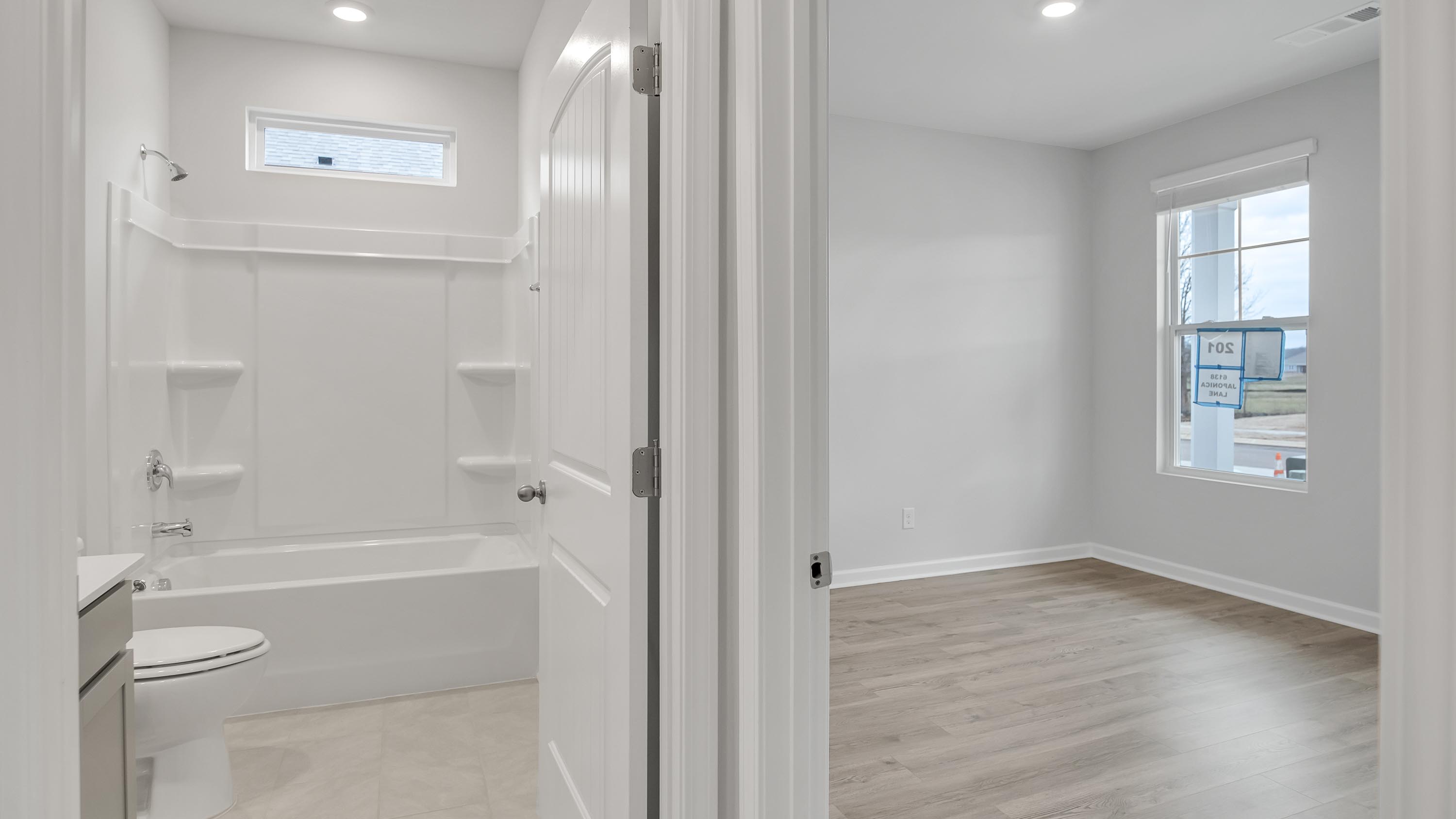 Family bathroom stylish designs in Legacy Farms at front of house near front flex-office, foyer