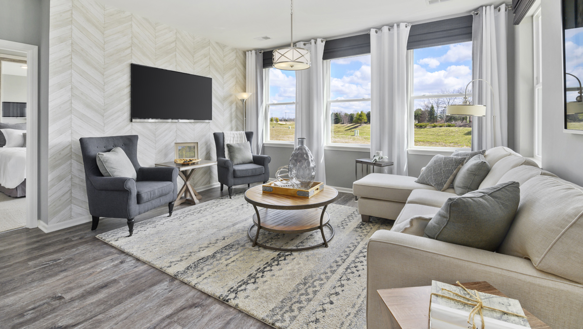 Living room with large windows for natural lighting.