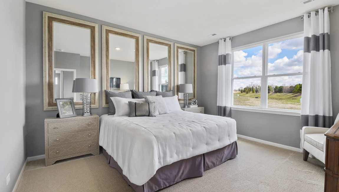 Primary bedroom with carpeted floors.