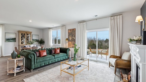 Living room in new, open-concept home with windows and natural lighting