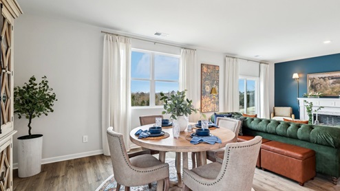 Dining room in new, open-concept home with windows and natural lighting