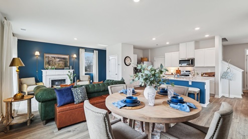Dining room in new, open-concept home with windows and natural lighting