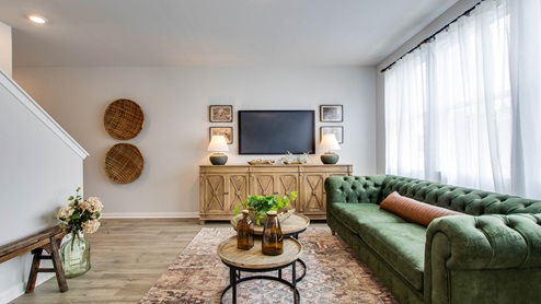 Living room in new, open-concept home with windows and natural lighting
