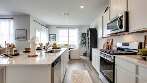 Modern kitchen with quartz countertops and stainless steel appliances