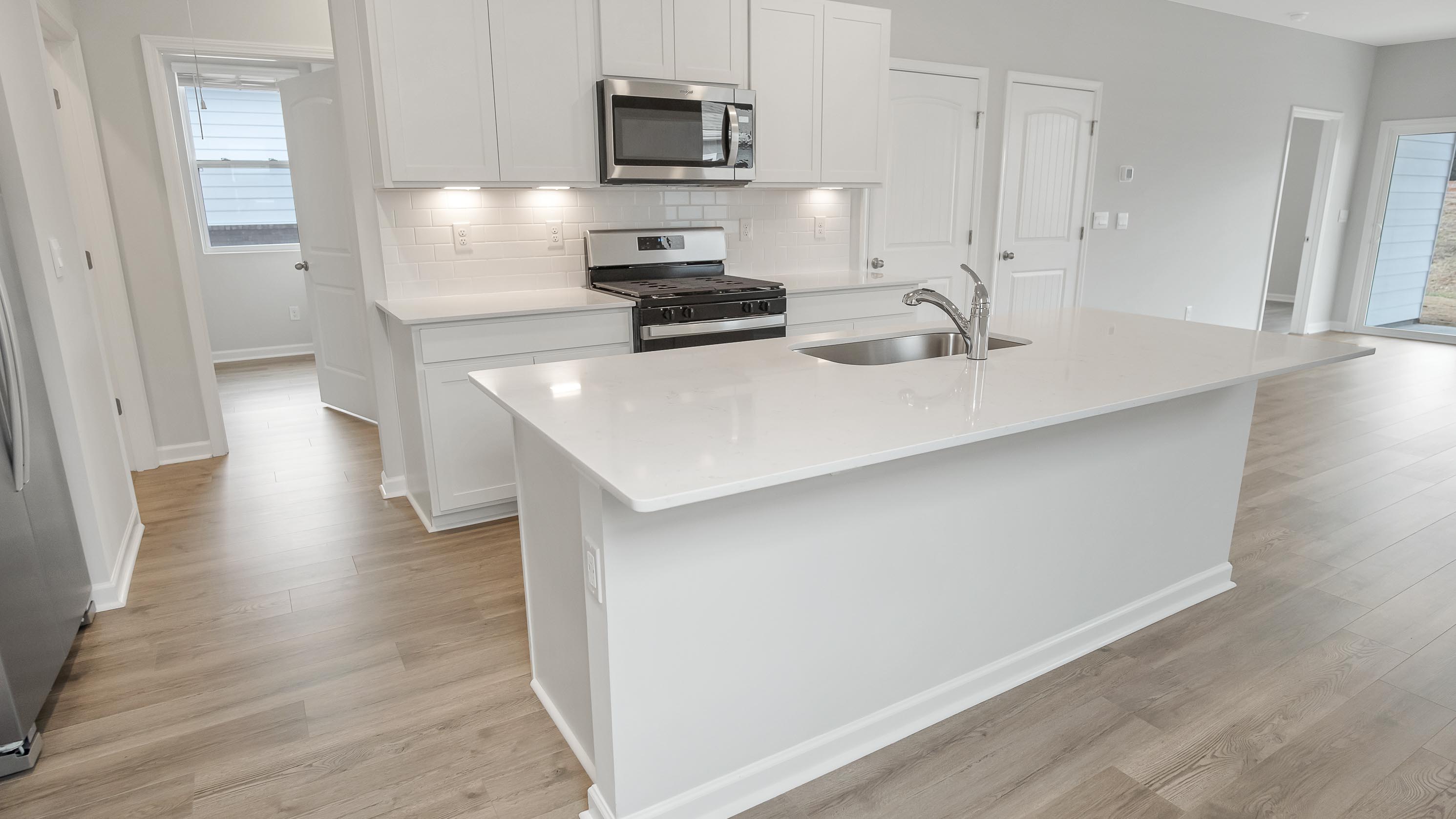 Modern kitchen with quartz countertops and stainless steel appliances