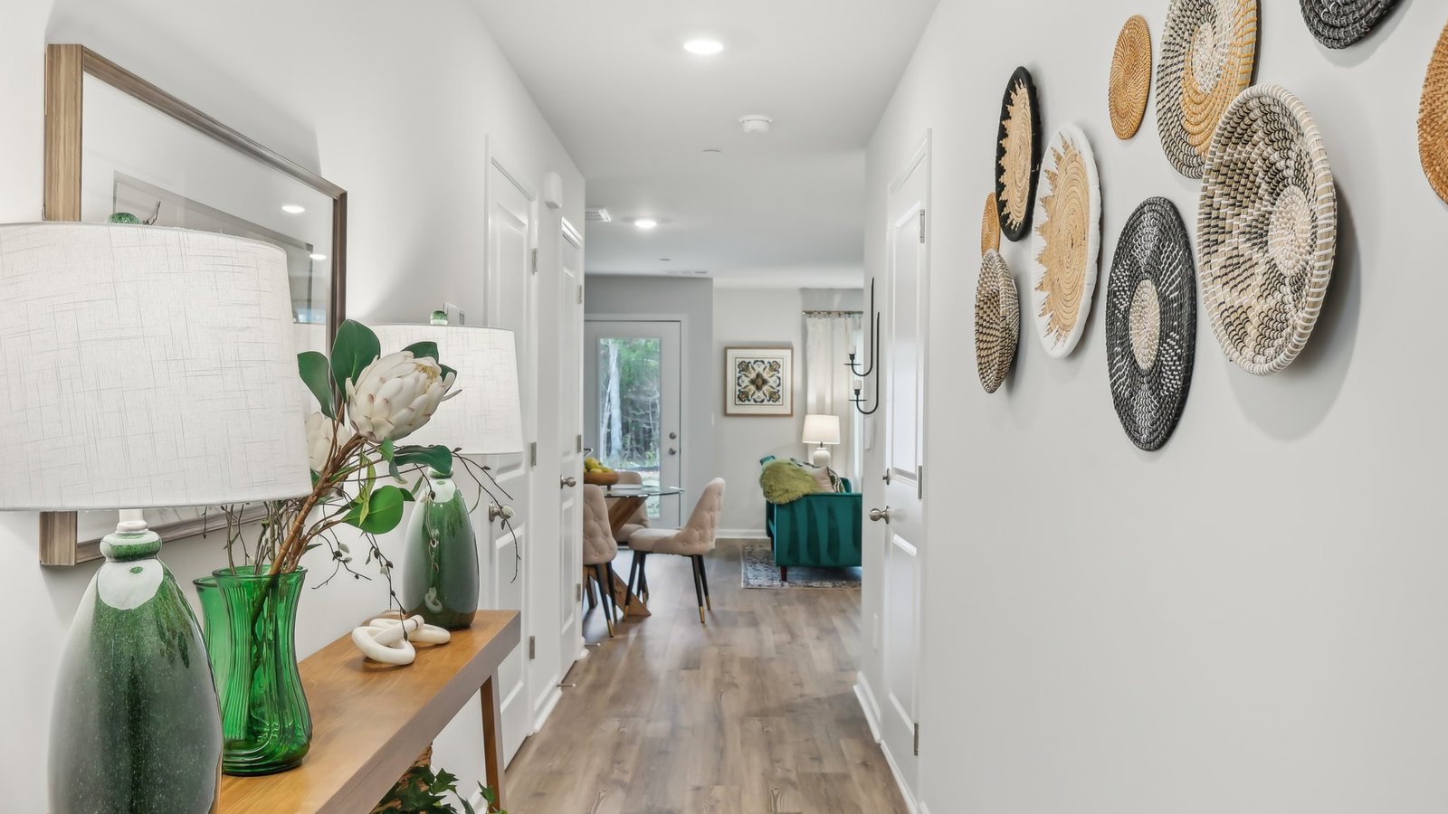 A foyer and front entry add a welcoming direct line of sight through the connected main dining, living, kitchen, and upstairs