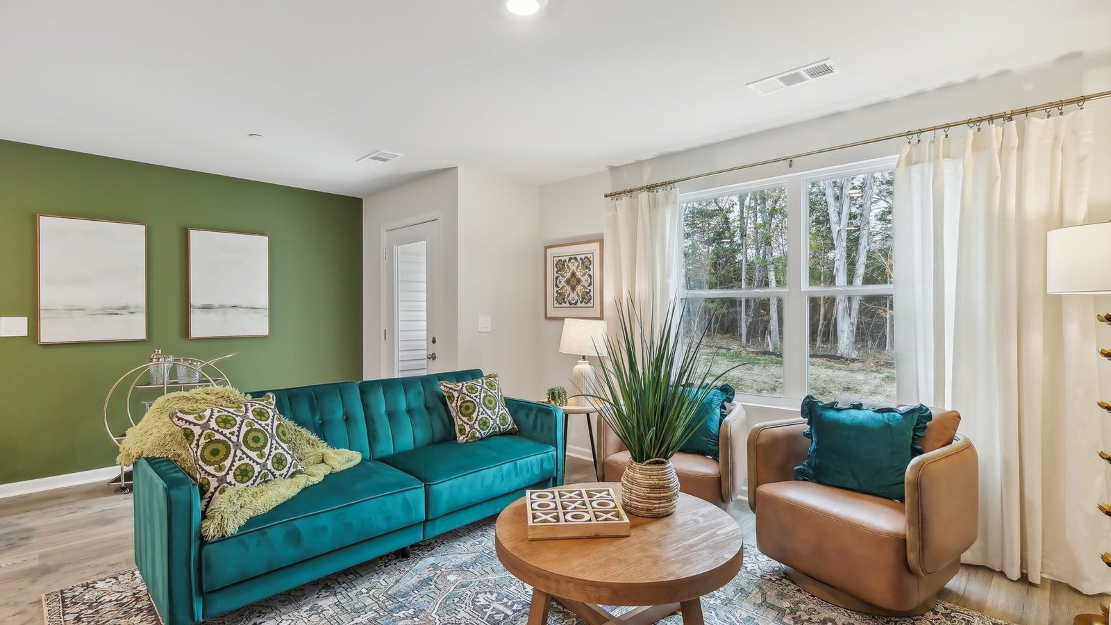 Living room features quality throughout, at the main entry, flowing to the kitchen, dining areas, at Saddle Trace Townhomes