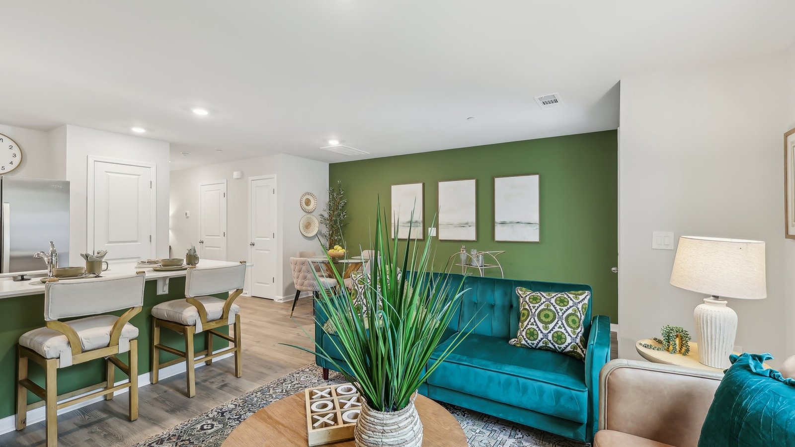 Spacious living room with view into our kitchen, with new appliance suite included and cabinet options at Saddle Trace Townhomes