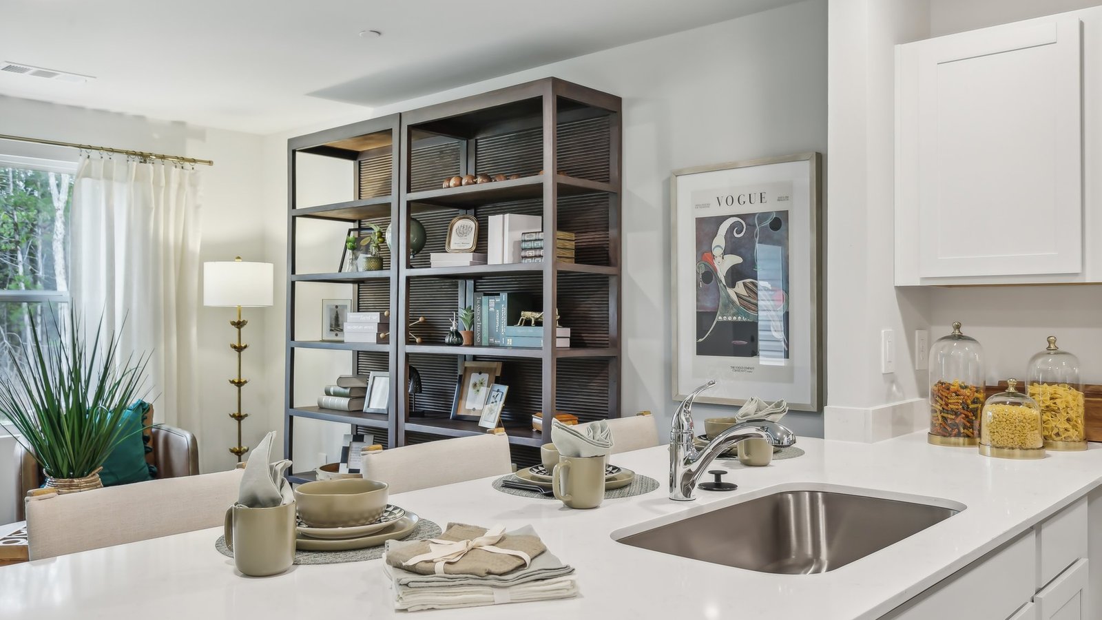View from kitchen into the living room, front door area, showing fresh open design at Saddle Trace Townhomes
