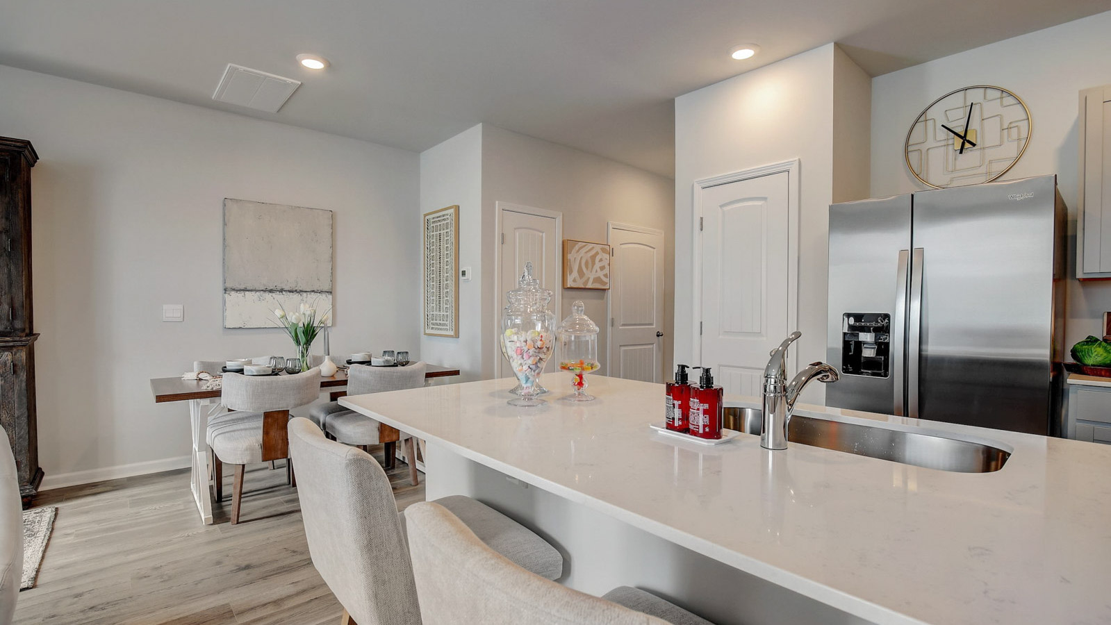 Central kitchen island anchors the townhome adding a dining option, full sink, pantry and storage, multi-prep zones