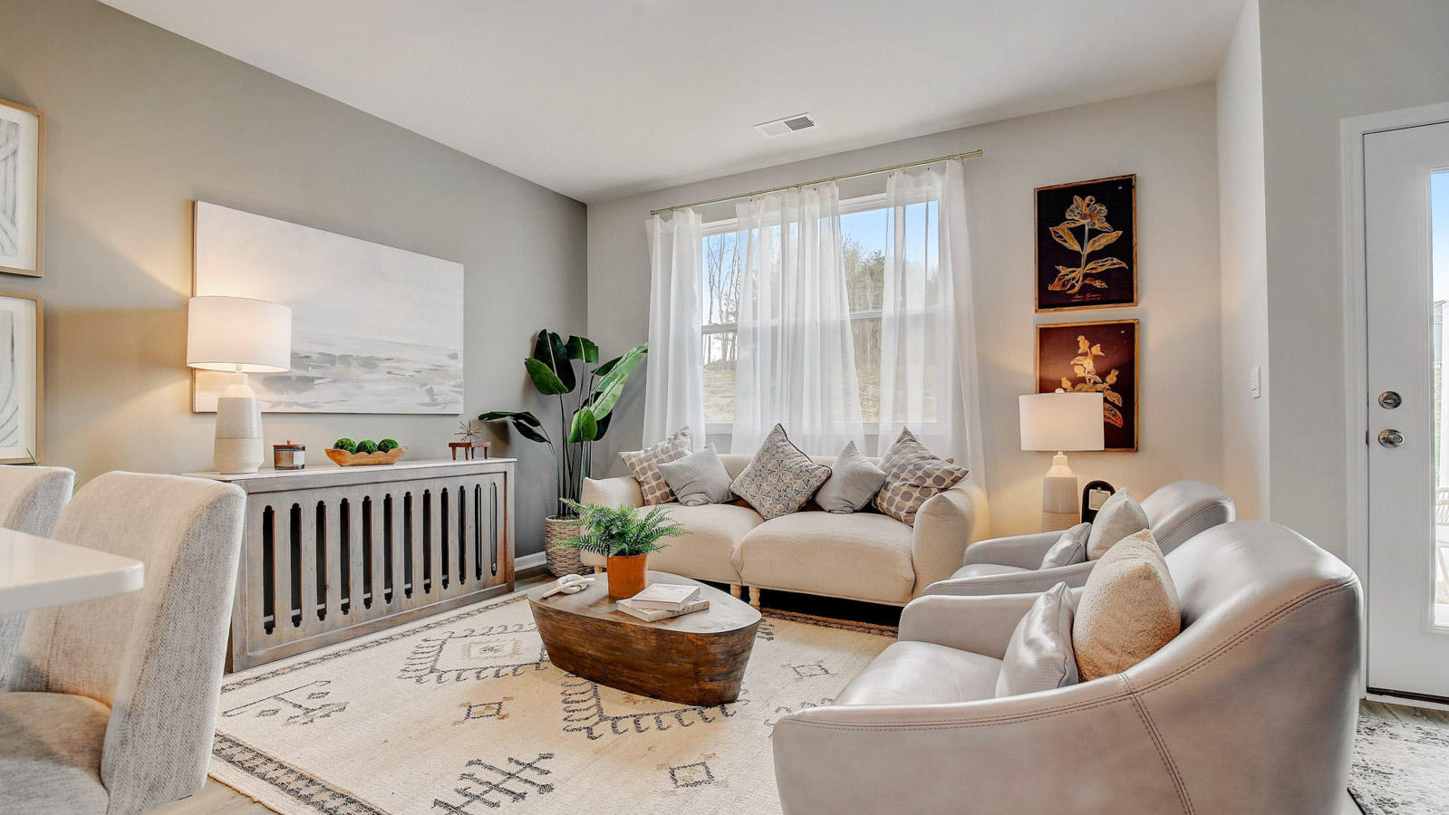 Living room features quality throughout, fresh open concept flowing to the kitchen, dining areas, at Saddle Trace Townhomes