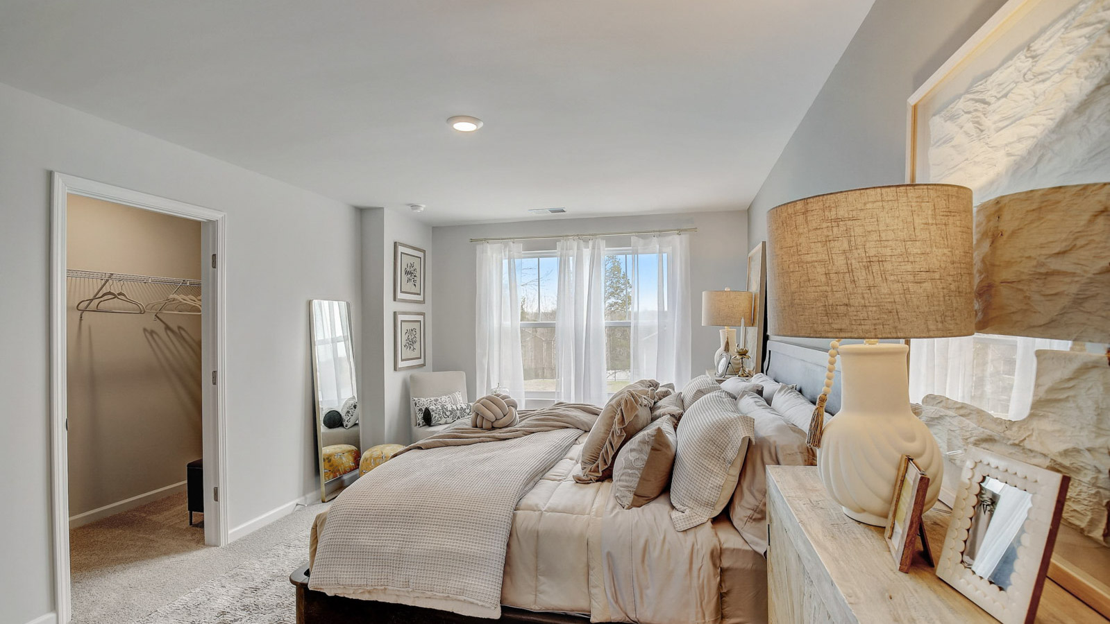 Owner’s suite offers natural window light, a spa-inspired ensuite bathroom, and spacious walk-in closet for everyday comfort