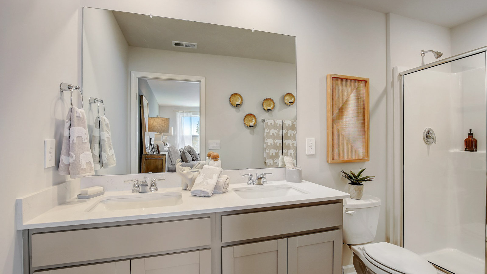 Owner’s ensuite in a new build home offers function with a walk-in closet, spa-like ensuite, stylish walk-in closet