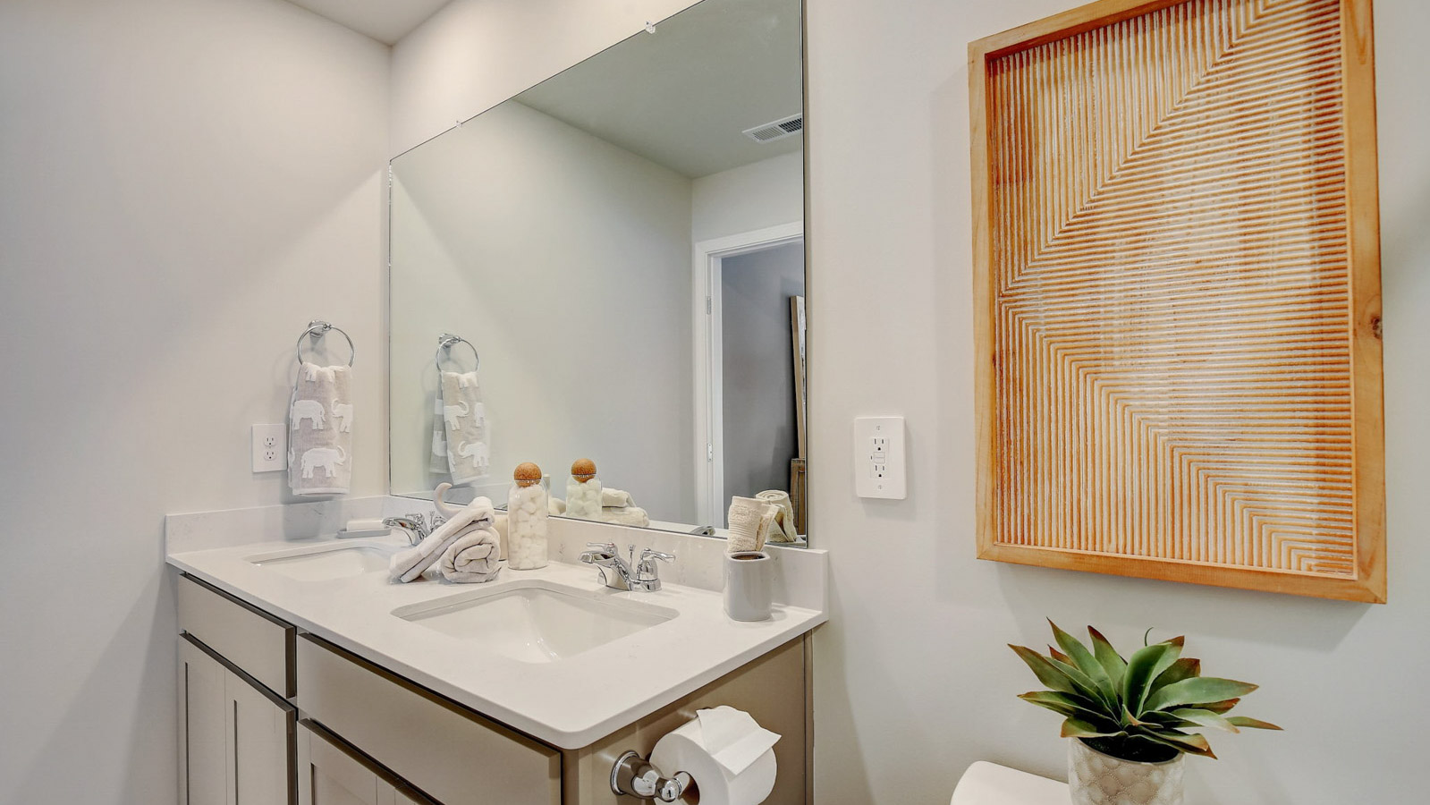 Primary ensuite in D.R. Horton's new townhome adds stylish touches, vanity with dual sinks, shower, tub, walk-in closet