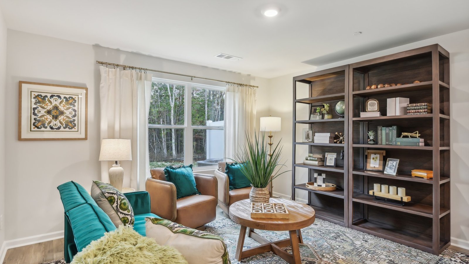 Living room with large window for natural lighting.